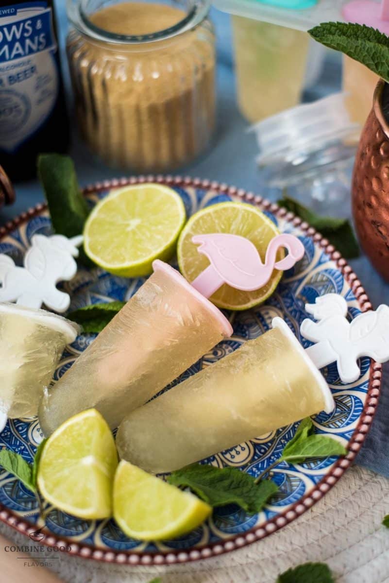 Gorgeous and refreshing Moscow mule popsicles placed on patterned plate.