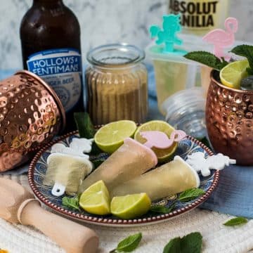 Gorgeous and refreshing Moscow mule popsicles placed on patterned plate.