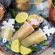 Gorgeous and refreshing Moscow mule popsicles placed on patterned plate.