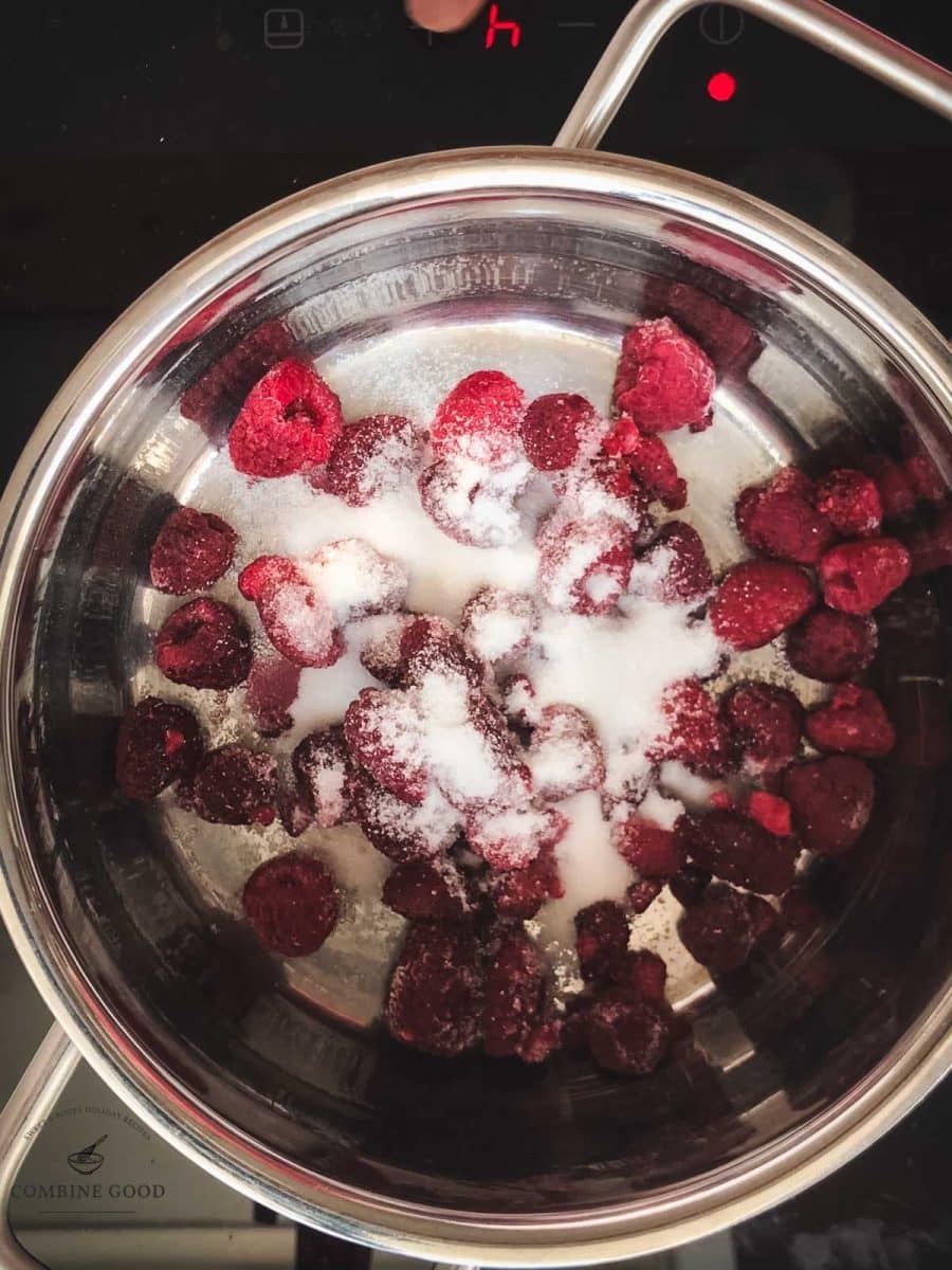 Combine sugar and raspberries in a saucepan.