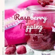 Vibrant raspberry cheesecake topping in a preserving jar, placed on white structured ground.