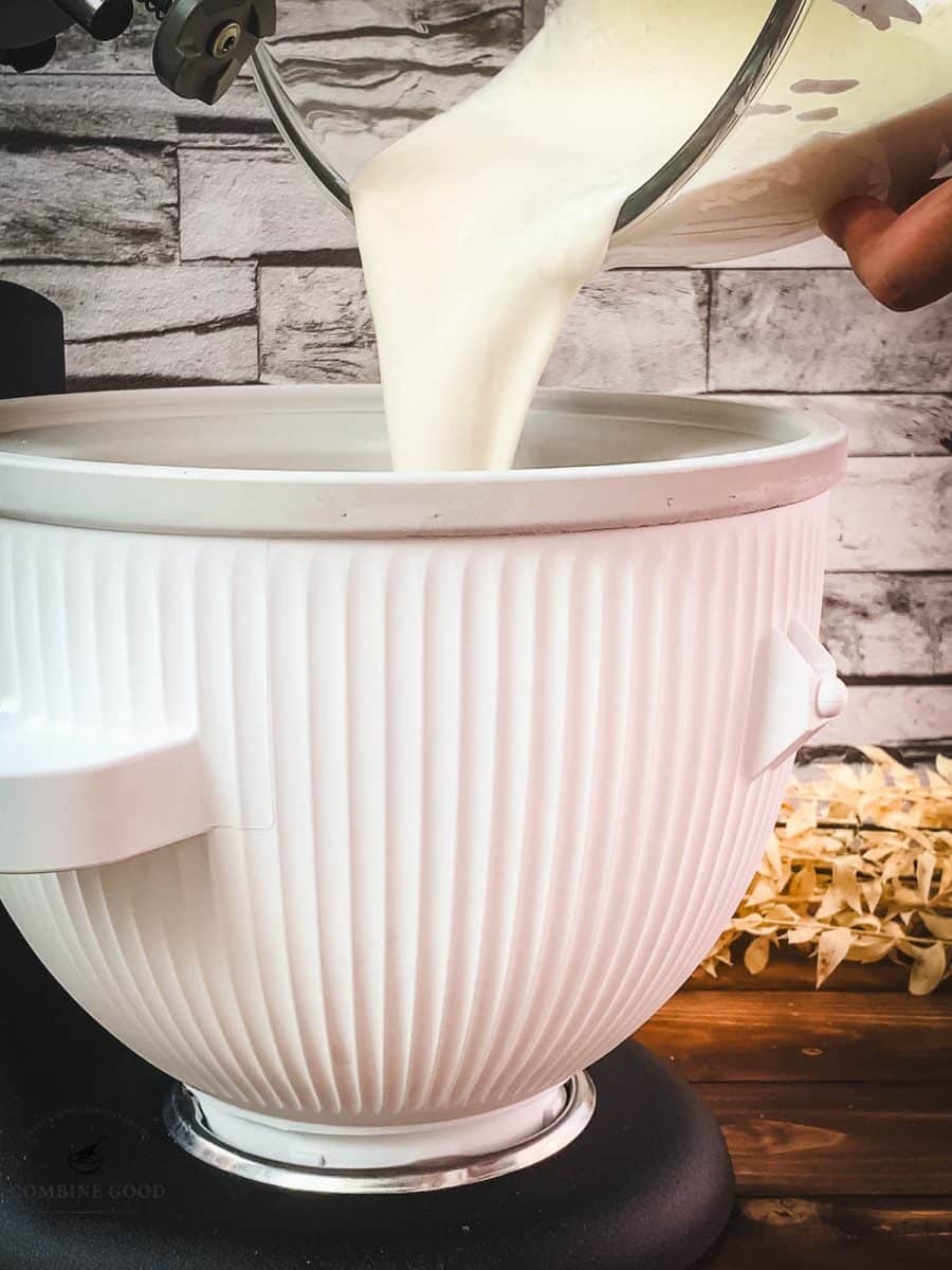 Pouring the sour cream mix into the well frozen ice cream maker bowl.