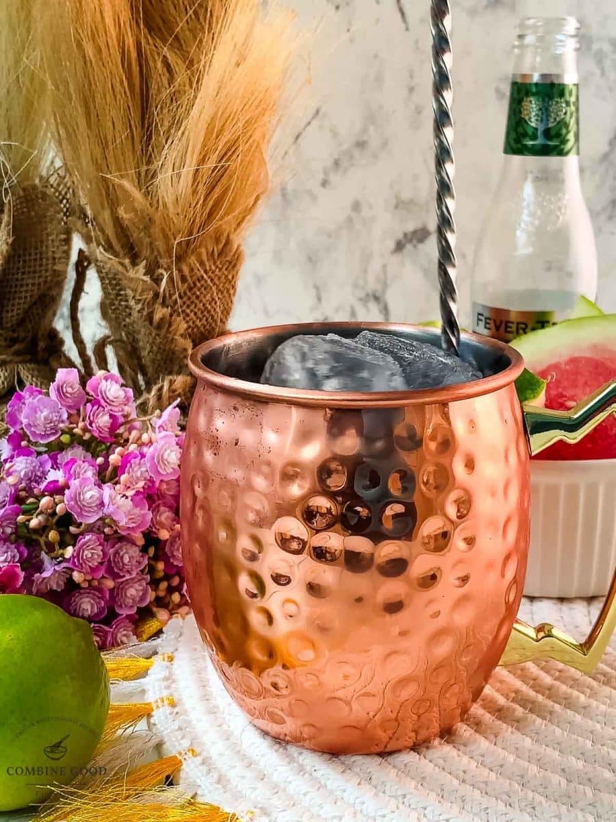 Stirring the watermelon Moscow mule, using a bar spoon.