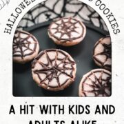 Hauntingly delicious spiderweb cookies, placed on black plate on spiderweb ground.