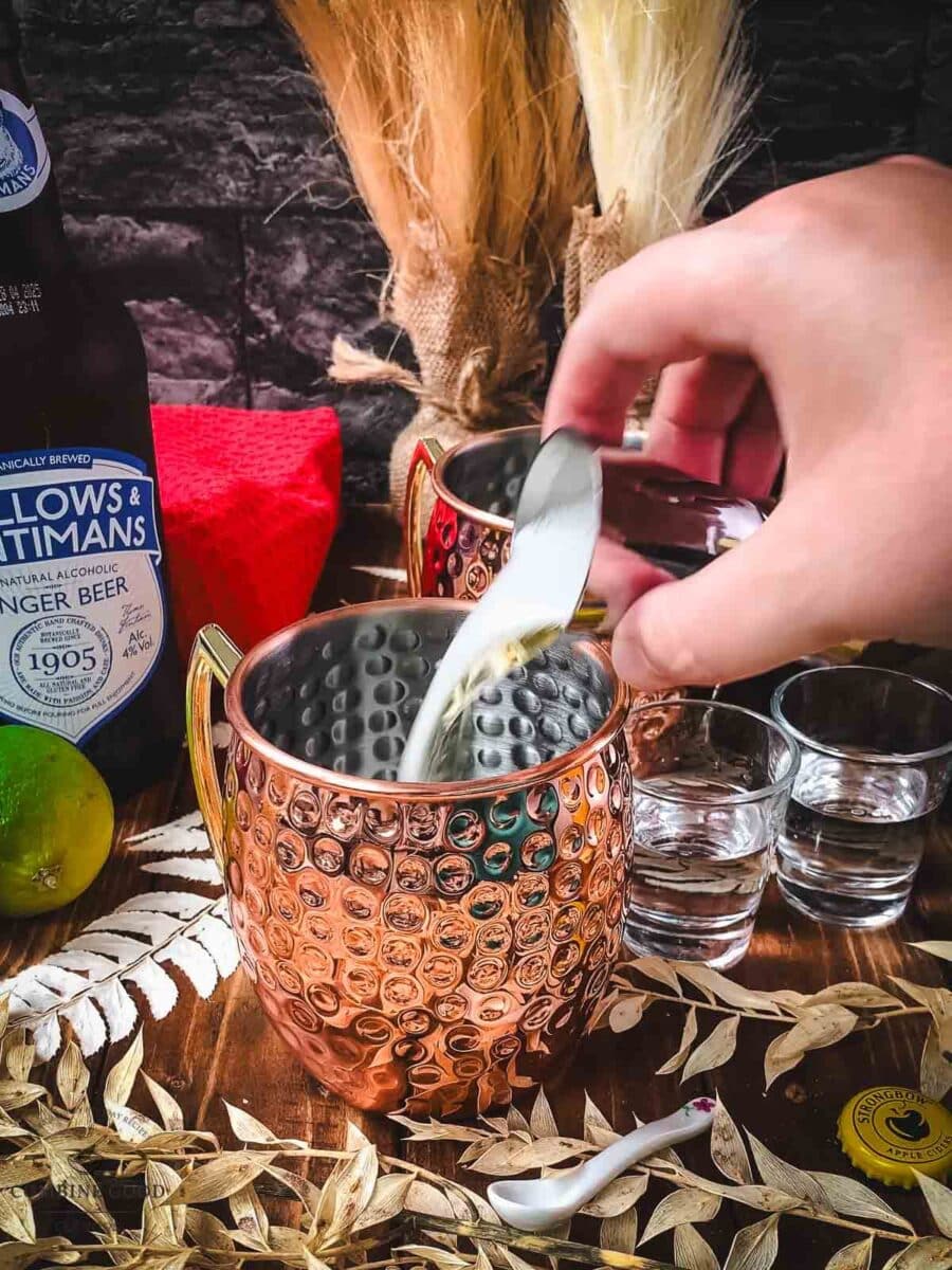 Add apple cider to your copper mugs.