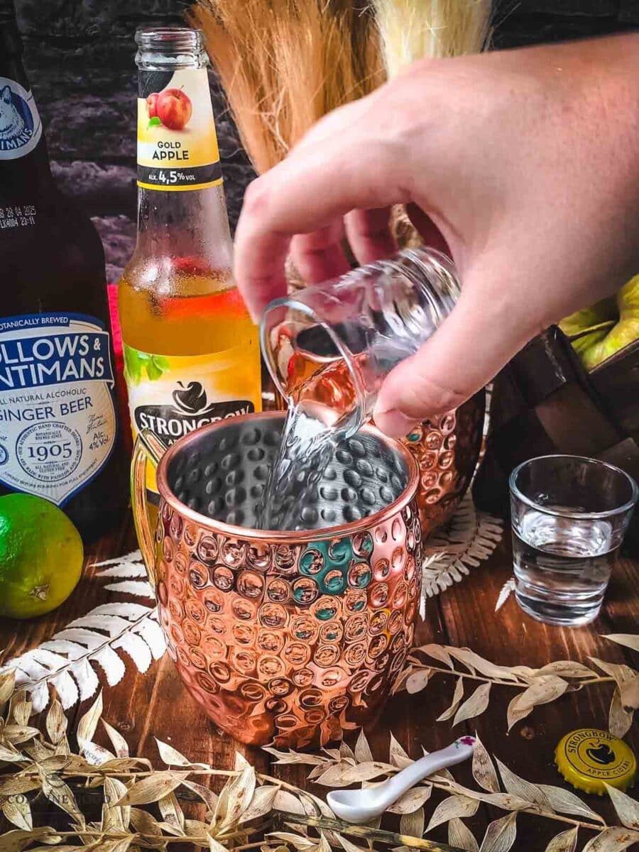 Add vodka to your copper mugs.