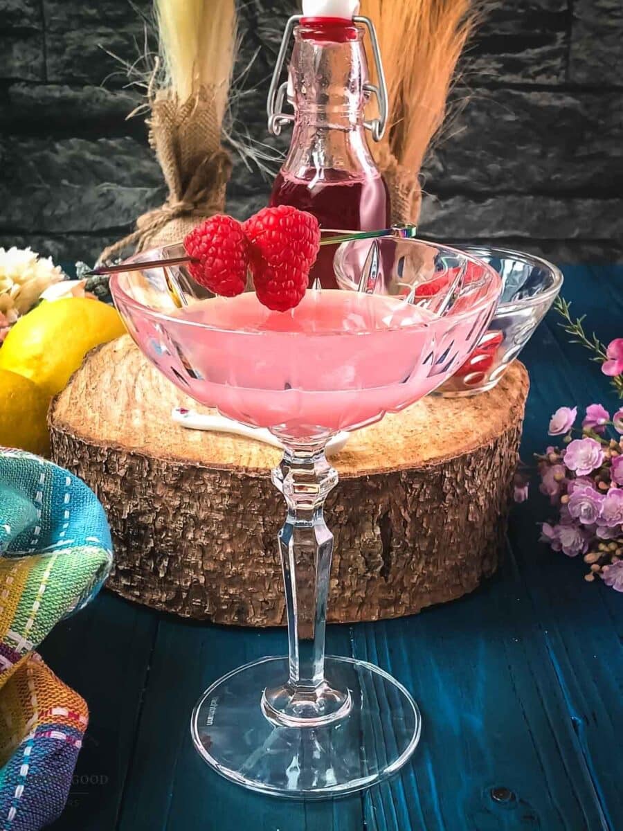 Garnish the clover club with fresh raspberries on a cocktail pick.