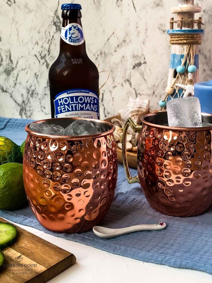 Fill the copper mugs with cubed ice.