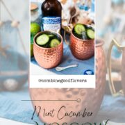 Refreshing mint cucumber Moscow mule served in copper mugs, placed on white and blue ground.