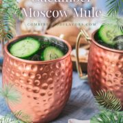 Refreshing mint cucumber Moscow mule served in copper mugs, placed on white and blue ground.