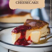 Delicious slice of semolina cheesecake with raspberry topping. Served on black and white plate.