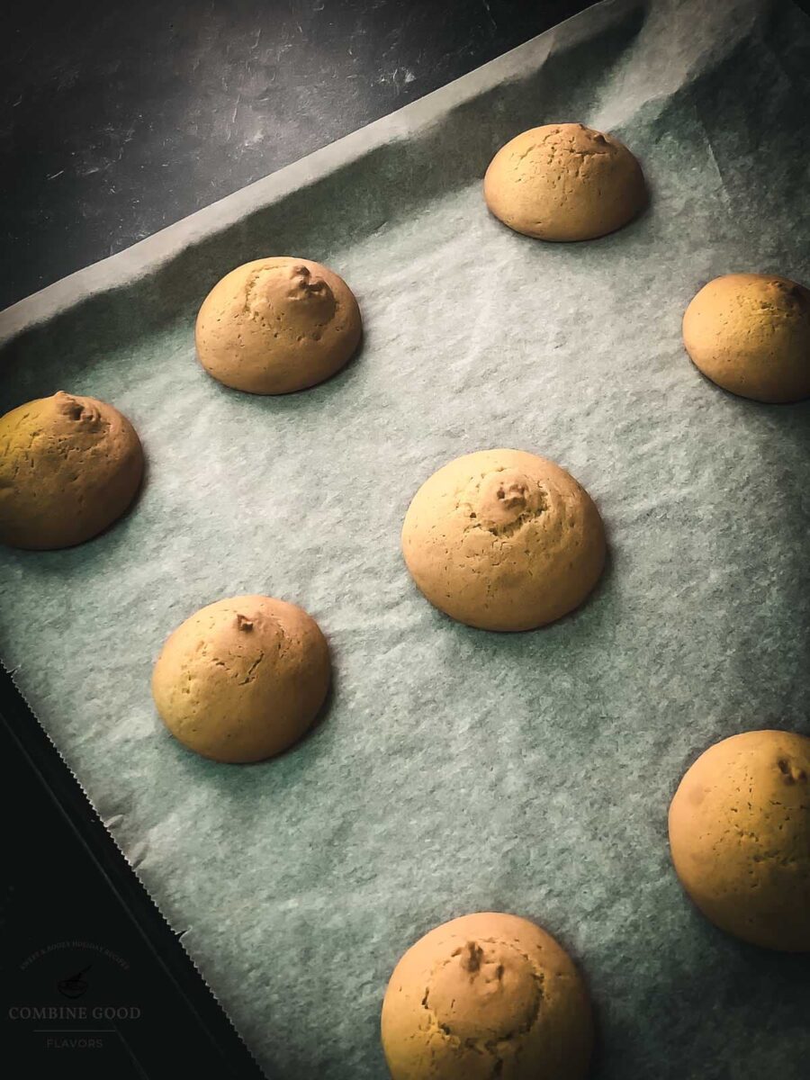 Cookies after baking on the baking sheet lined with parchment paper.