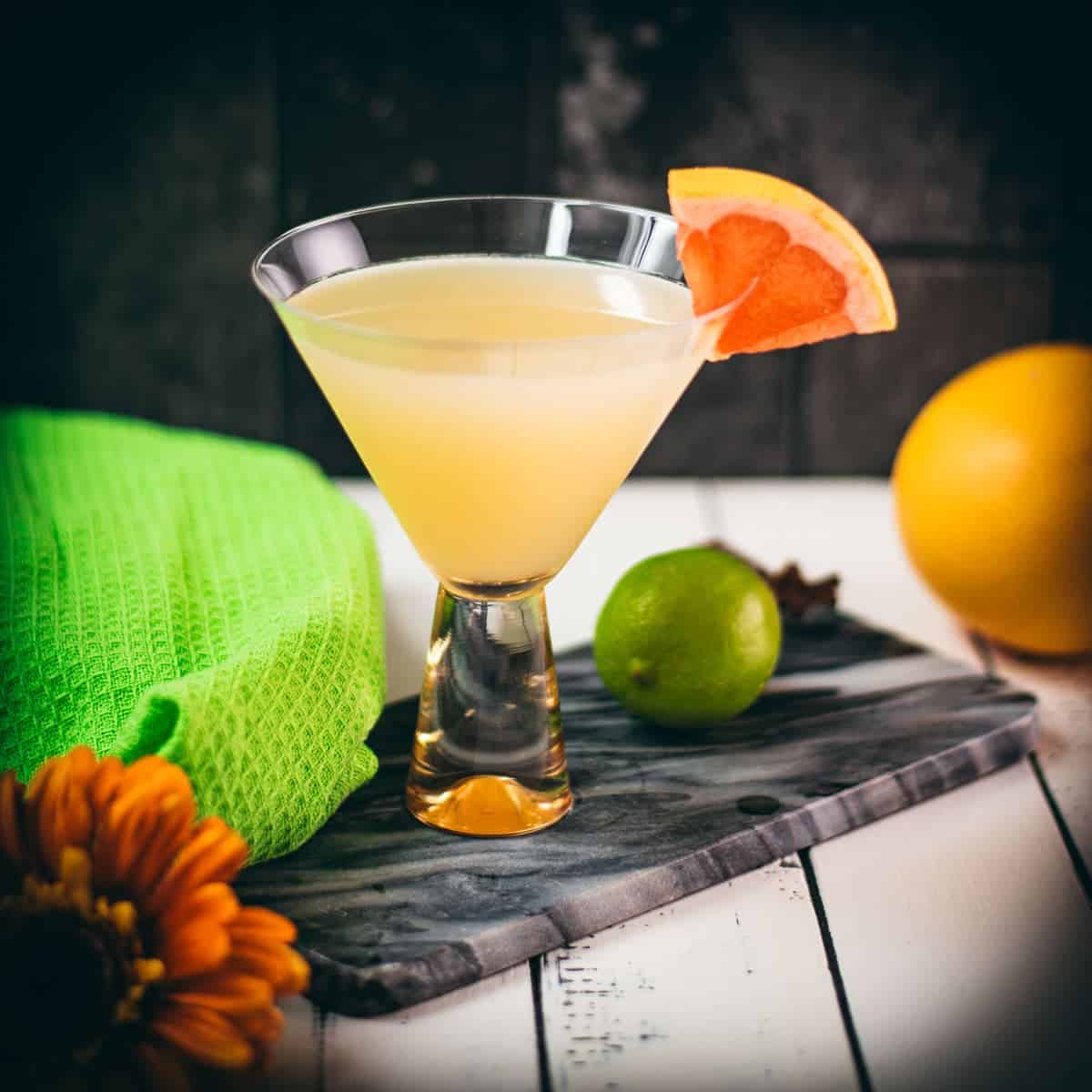 Vibrant Hemingway daiquiri, with a tart and slightly sweet flavor. Served in a gorgeous cocktail glass and placed on a marbled plate.