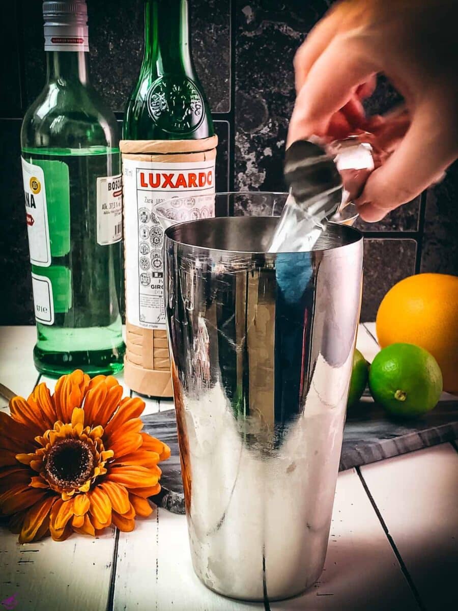 Add the maraschino liqueur to the cocktail shaker.