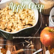 Casserole filled with freshly baked apple crisp on wooden ground.