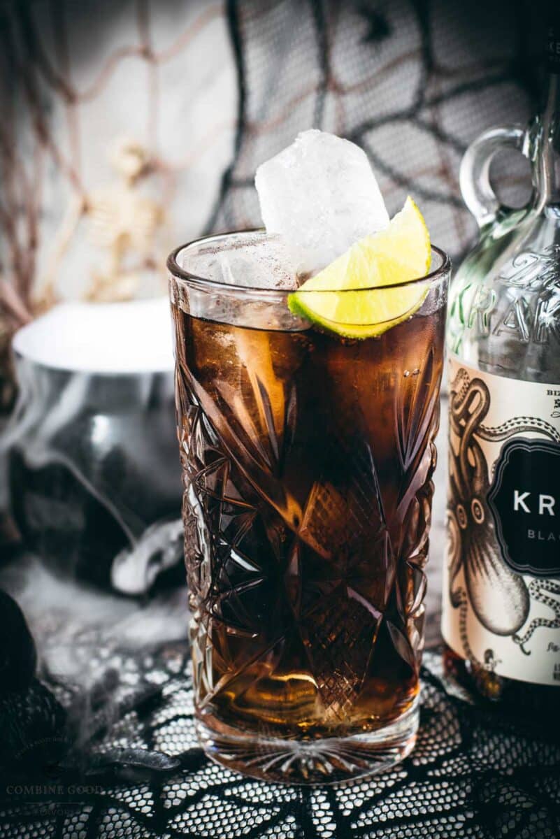 Gorgeous highball glass filled with delicious Kraken Cola. Served spookily next to a little spider on a spider web.