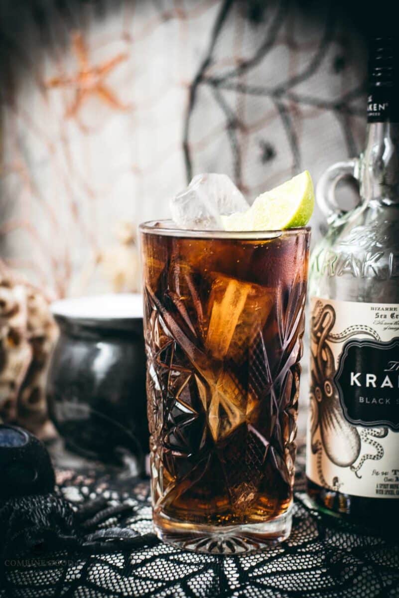 Gorgeous highball glass filled with delicious Kraken Cola. Served spookily next to a little spider on a spider web.