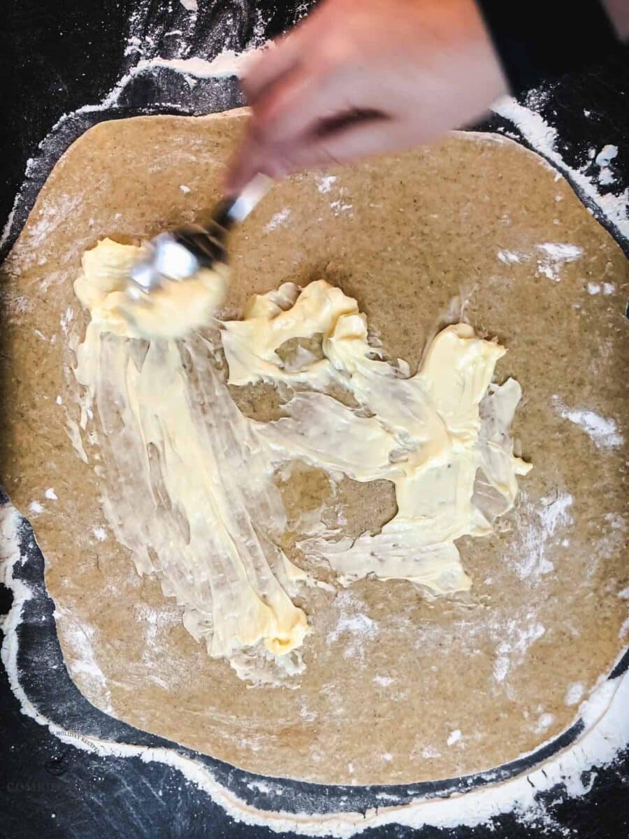 Spread the remaining butter evenly over the dough.