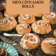 Yummy mini cinnamon rolls, drizzled with homemade sugar icing, placed on cooling rack.