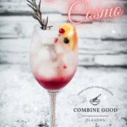 Gorgeous wineglass filled with delicious layered Prosecco cosmo. Garnished with a rosemary twig, an orange slice, and red and black currants.