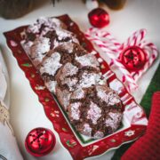 Gorgeous chocolate peppermint crinkle cookies placed on christmassy plate.