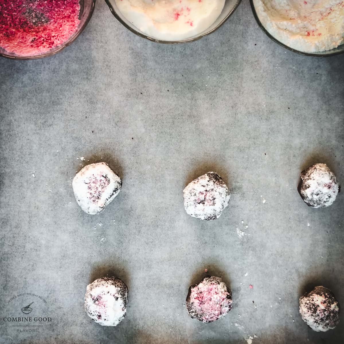 Sugar candy cane covered dough balls on a baking sheet lined with parchment paper.