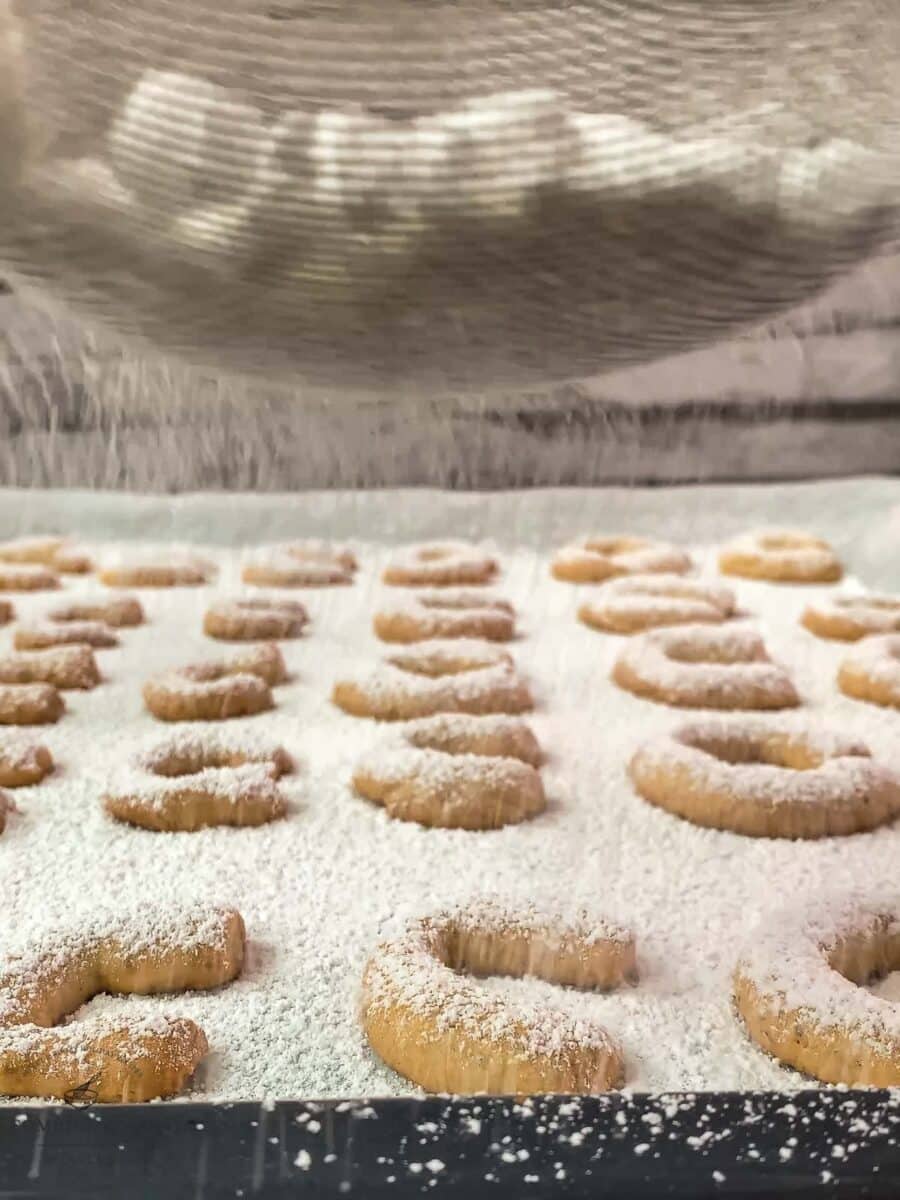 Dust the warm vanilla crescent cookies with a powdered sugar vanilla sugar mix.