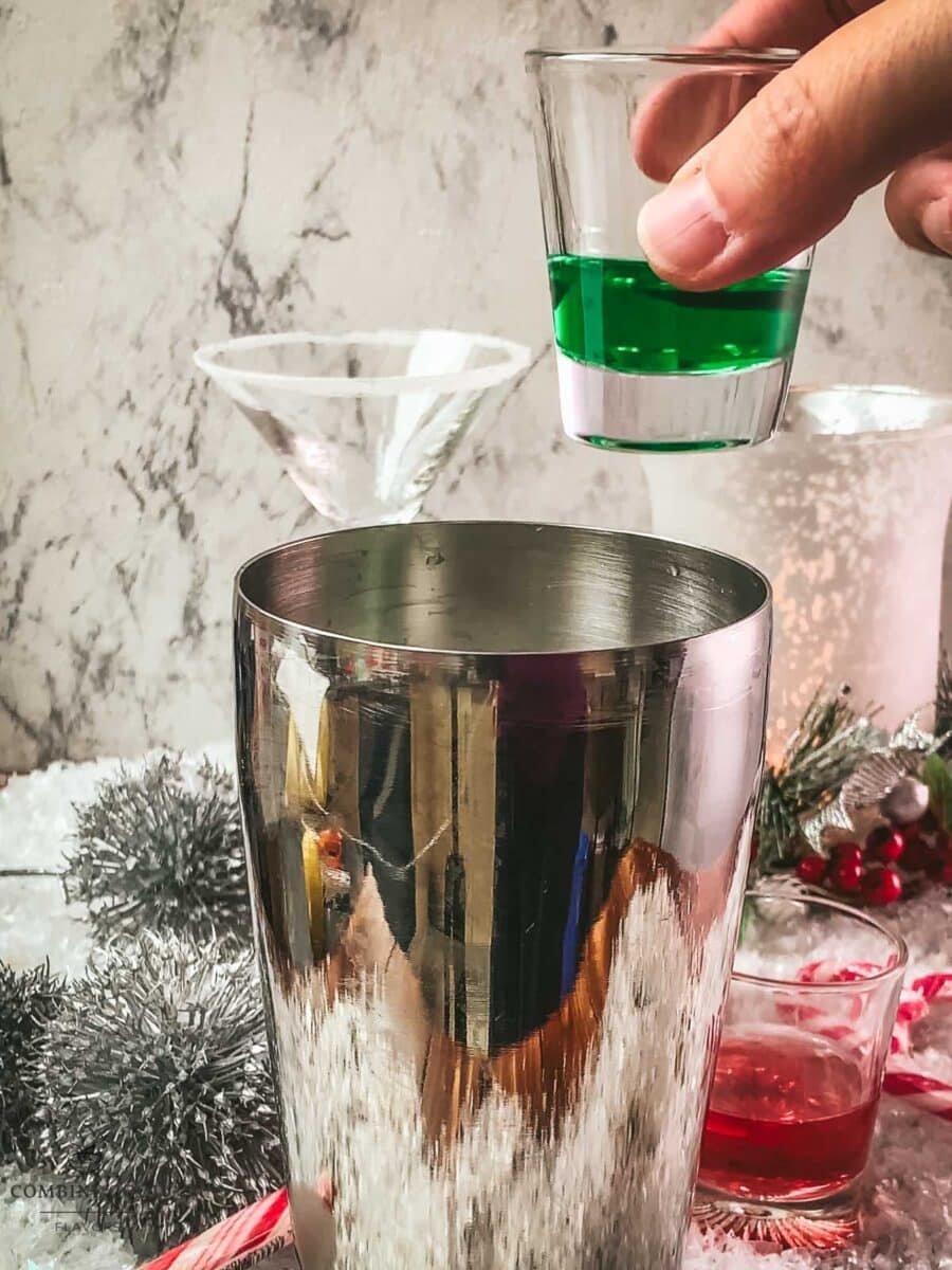 Add peppermint liqueur to the cocktail shaker.