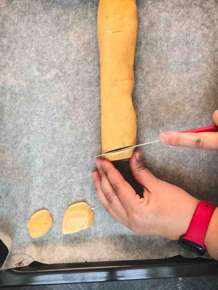 Cut the cold dough roll into finger thick slices.