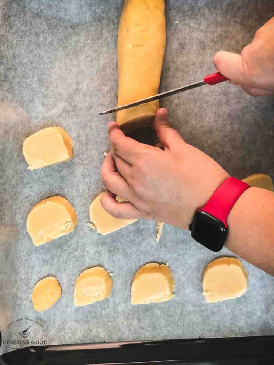 Cut the cold dough roll into finger thick slices.