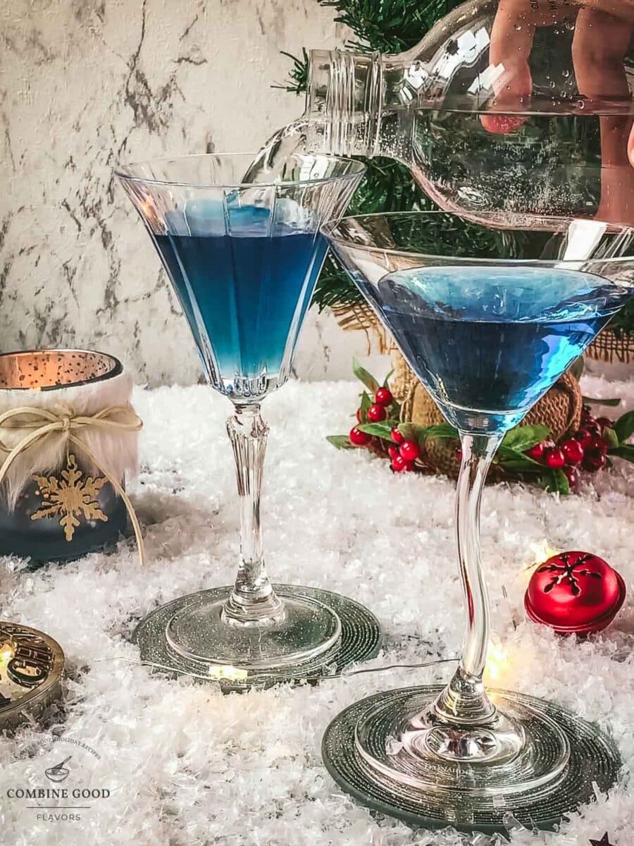 Top the blue Christmas cocktail off with sparkling water.