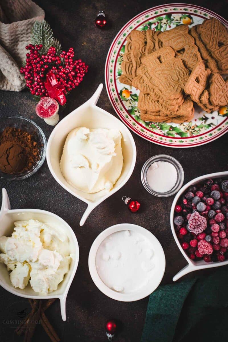 Ingredients mini Christmas trifles - Speculoos, granulated sugar, frozen berries, mascarpone, curd cheese, vanilla sugar, cocoa, and cinnamon.