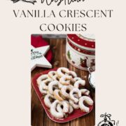 Delicious traditional Austrian vanilla crescents stacked on christmassy plate, placed next to a Christmass cookie jar.