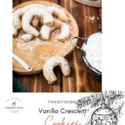 Delicious traditional Austrian vanilla crescents stacked on wooden plate, placed next to a Christmassy cookie jar.