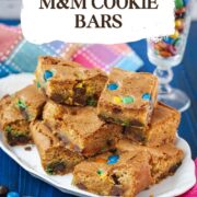 Delicious M&M cookie bars on white plate.