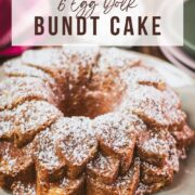 Gorgeous six egg yolk bundt cake, dusted with powdered sugar, and placed on white plate.