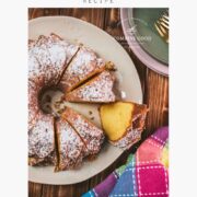 Gorgeous six egg yolk bundt cake, dusted with powdered sugar, and placed on white plate.