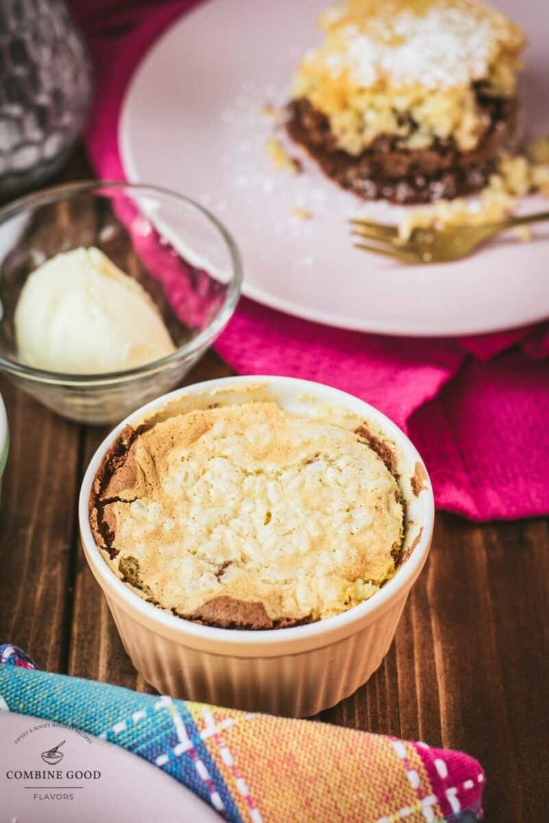 Delicious marbled rice pudding mini casserole placed on wooden board next to a scoop of vanilla ice cream.