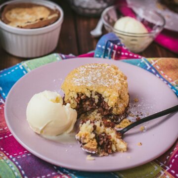 Delicious marbled rice pudding mini casserole on pink plate. Served with a scoop of vanilla ice cream.