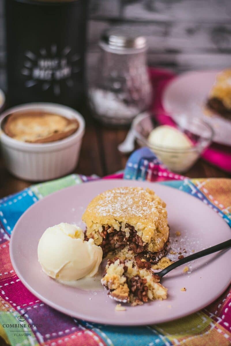 Delicious marbled rice pudding mini casserole on pink plate. Served with a scoop of vanilla ice cream.