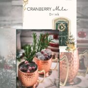 Two copper mugs filled with a delicious cranberry Moscow mule, placed on mirrored coaster and garnished with rosemary twigs and frozen cranberries.