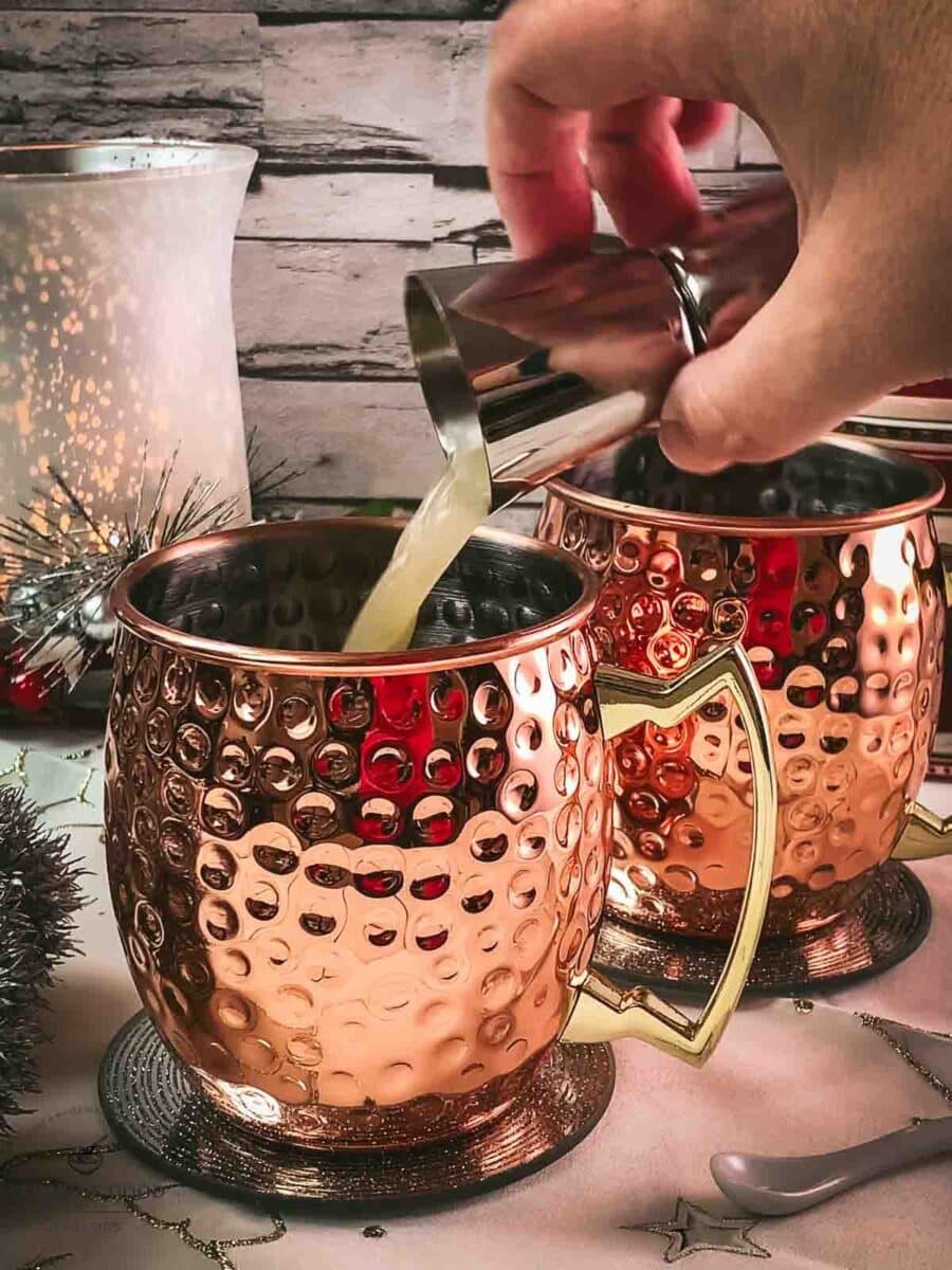 Add freshly squeezed lime juice to the copper mugs.