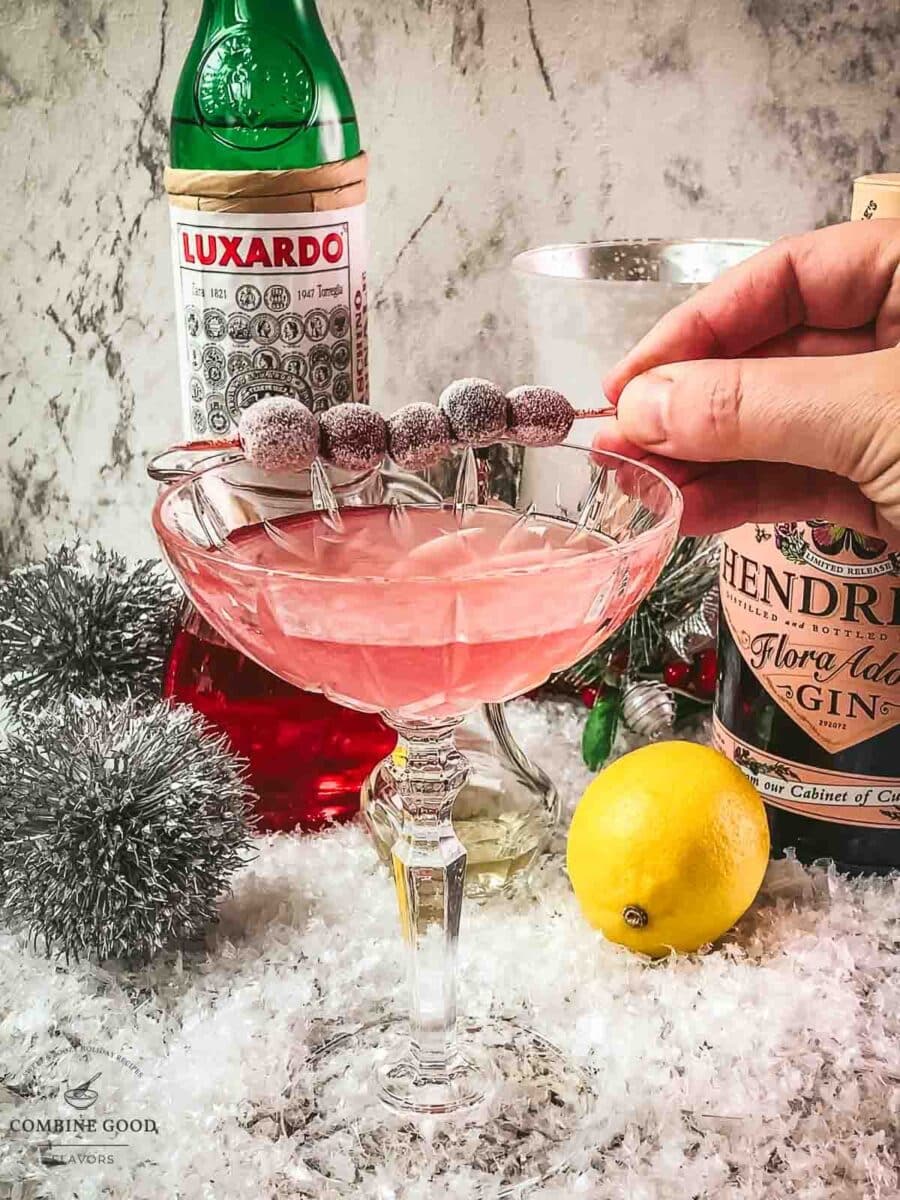 Place the frosted cranberries with the cocktail skewer on top of the glass.