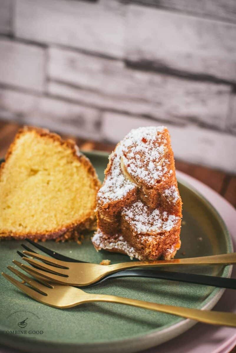 Gorgeous six egg yolk bundt cake slice, dusted with powdered sugar, and placed on green plate.