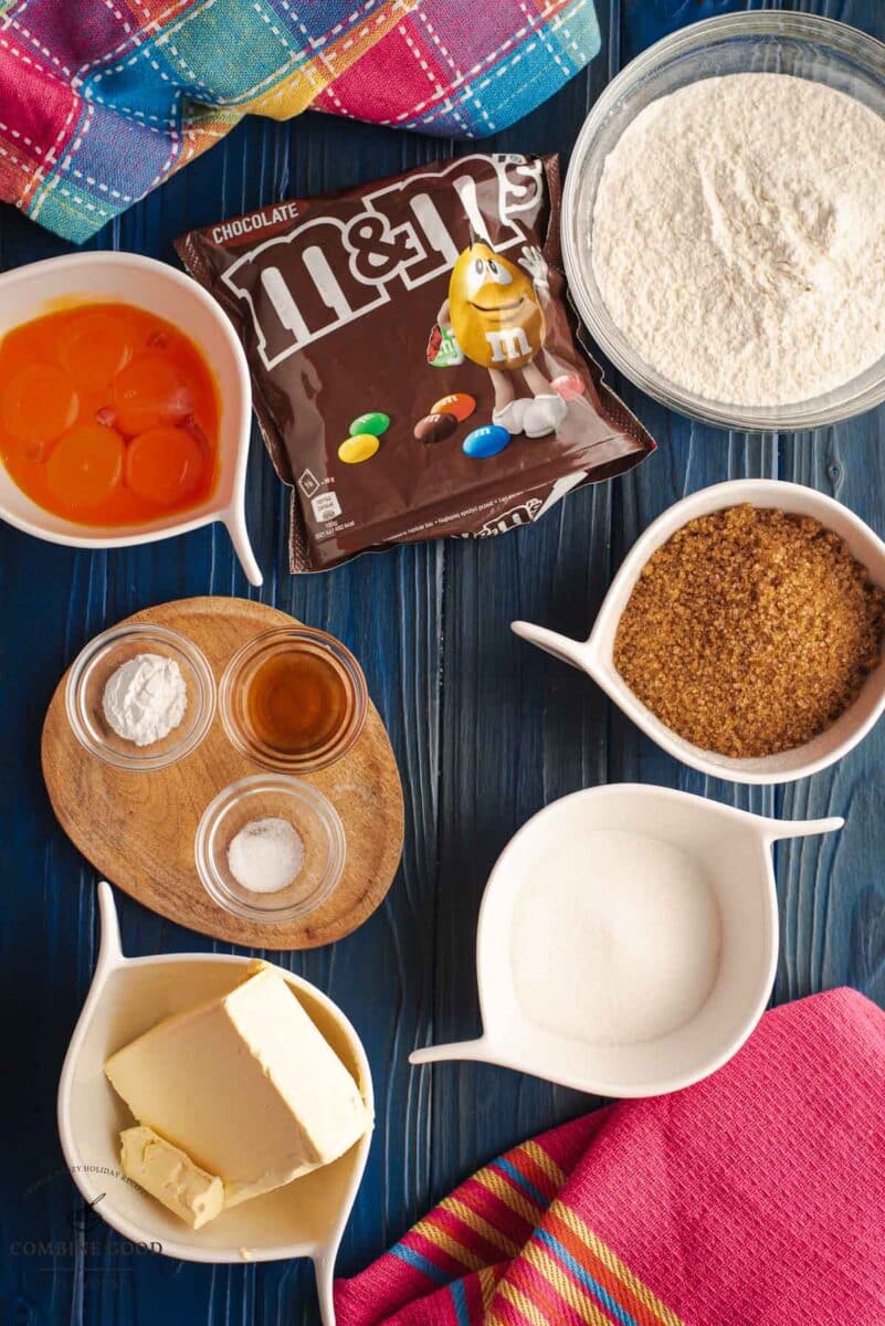 Ingredients M&M cookie bars - brown sugar, granulated sugar, cake flour, egg yolks, baking powder, salt, butter, vanilla extract, and M&Ms.