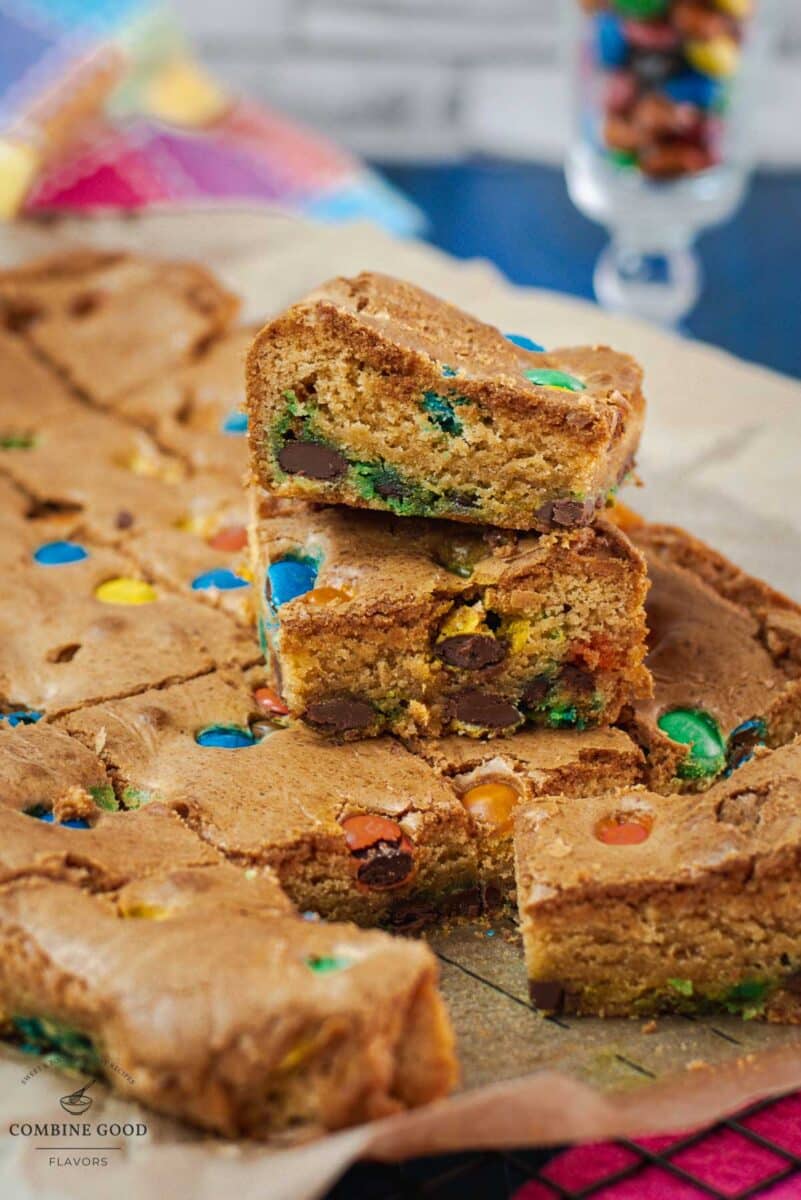 Delicious M&M cookie bars on parchment paper.