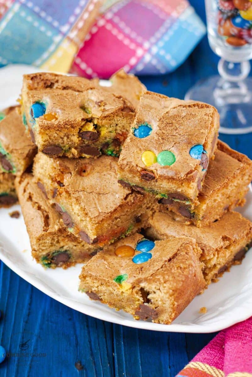 Delicious M&M cookie bars on white plate.