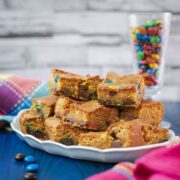 Delicious M&M cookie bars on white plate.