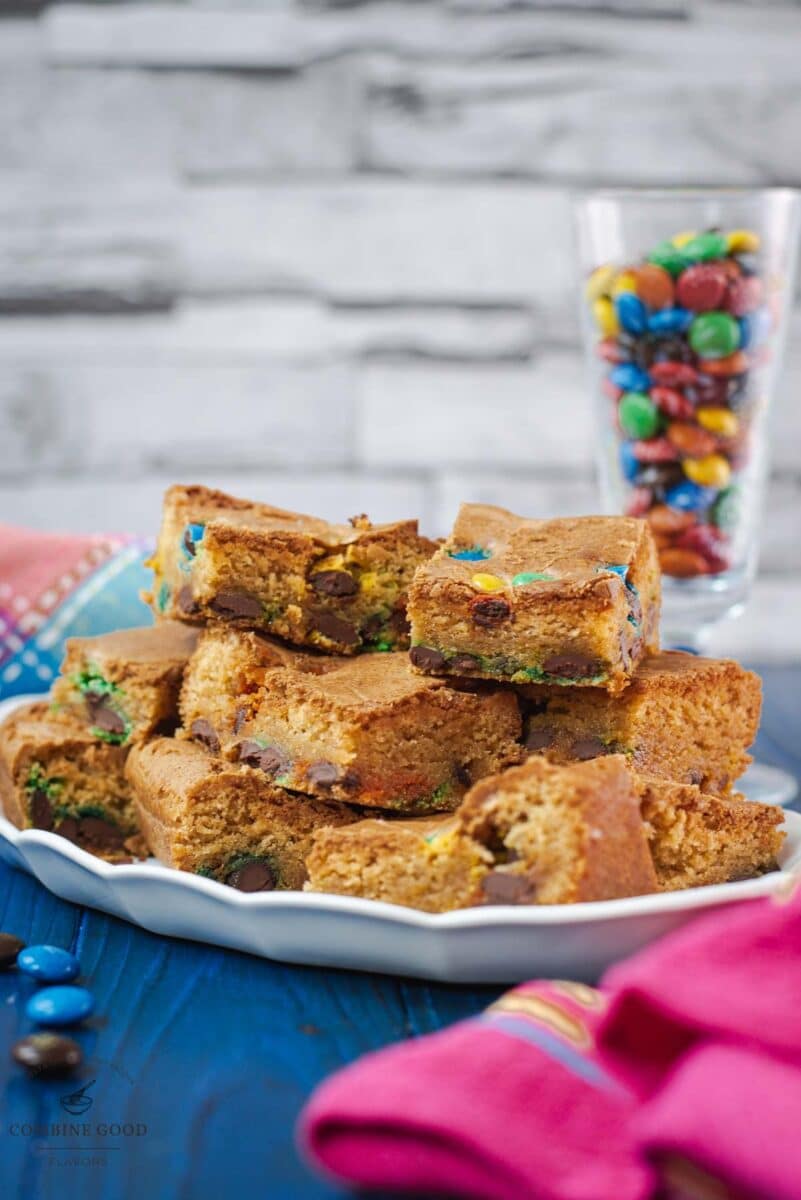 Delicious M&M cookie bars on white plate.