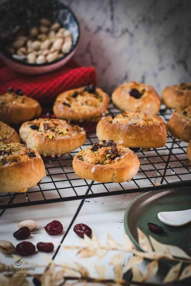 Delicious, mini pistachio sweet rolls on cooling rack.